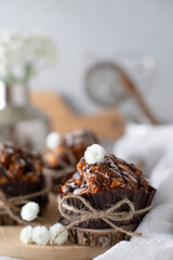 Still life with cakes covered with white icing and chocolate on the kitchen table