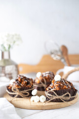 Still life with cakes covered with white icing and chocolate on the kitchen table