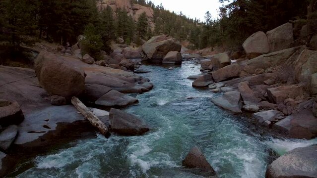Aerial drone cinematic Colorado down the river fisherman paradise Deckers Cheesman Canyon Evergreen Conifer Boulder shaded mountainside forest peaceful water boulder rocks forward movement flight 4k