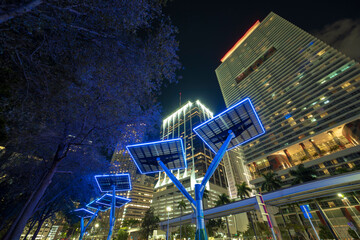 Downtown district of Miami city with photovoltaic panels mounted on metal poles for electricity...