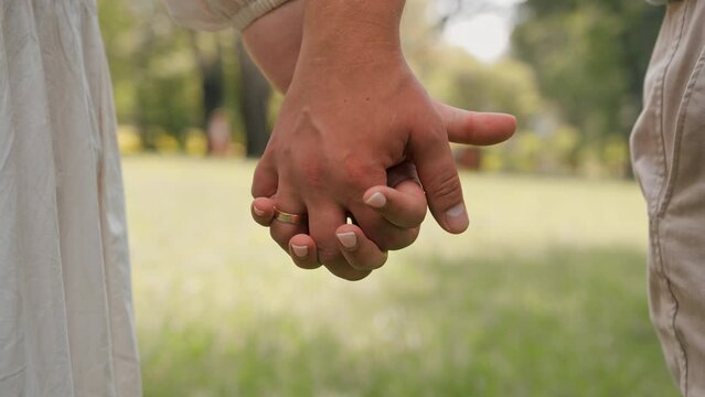 hands of couple in love close-up couple holding hands concept of support care love happy family