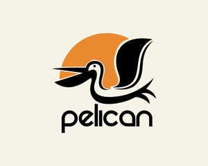 Obraz premium flying pelican at sun background logo icon symbol design template illustration inspiration