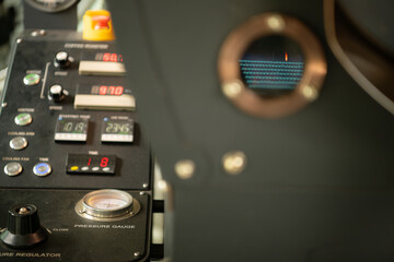 Coffee roaster machine with roasted coffee beans, close up