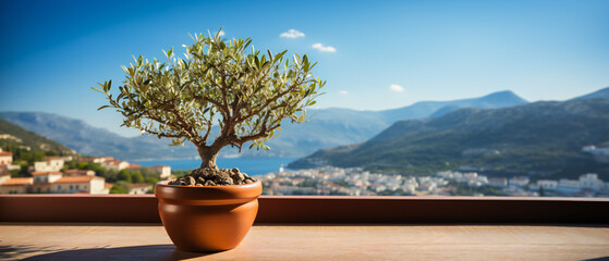 Olive tree in terra cotta clay pot on white terrace under clear blue sky with beautiful mountains view. Summer vacation conceptual background. Generative Ai.