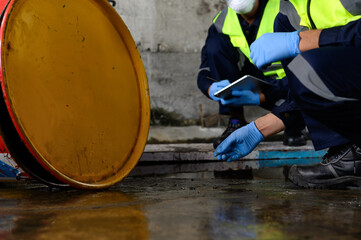 Two Officers of Environmental Engineering wearing masks inspected Oil Spill.