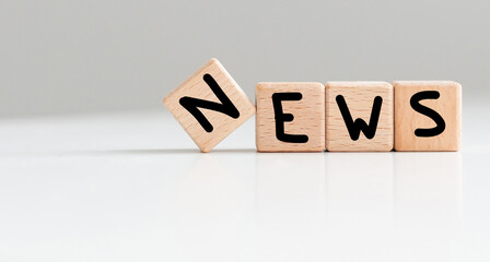 News symbol. Concept word News on wooden cubes. Beautiful white background. Business and News...