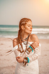 Woman portret sea white dress. Model in boho style in a white long dress and silver jewelry on the...