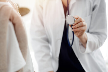 Doctor and a kid patient. Physician is holding stethoscope and ready to examine boy. Perfect health concept in medicine