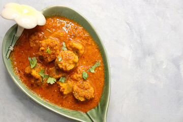 Rajasthani Gatta Curry or Besan Ke Gatte Ki Sabzi. Gatte are gram flour roundels or chickpea flour dumplings are cooked in a spicy, tangy yogurt based curry. delicacy of Rajasthan, India. copy space.