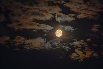 Dark night sky with full Moon and colored clouds. HDR photo taken through a telephoto lens