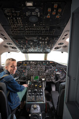 Young girl at the controls of a large commercial airplane