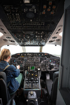 Young girl at the controls of a large commercial airplane