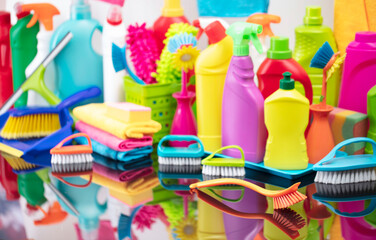 Fototapeta na wymiar Office and house cleaning theme. Set of colorful cleaning products on shining table.