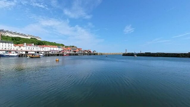 Panning shot of the River Esk and harbour in the seaside town of Whitby on the North Yorkshire Coast