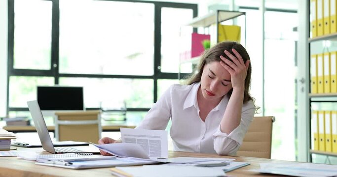 Frustrated businesswoman entrepreneur reading letter with bad news about project failure or bankruptcy in office. Sad manager or seo bankruptcy letter
