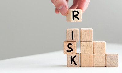 Man removes blocks with the word Risk. The concept of reducing possible risks. Insurance, stability support. Legal protection of business interests. Financial pillow. Favorable investment climate.