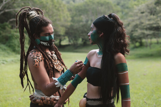 Native man and woman painting their skin