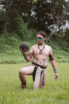 Indigenous man looking at a rubber ball