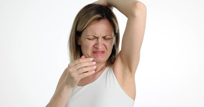 Beautiful girl is disgusted with sweaty armpits. Feminine hygiene problem