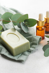 Soap, eucalyptus, aroma essential oil,  spa objects on a concrete background.