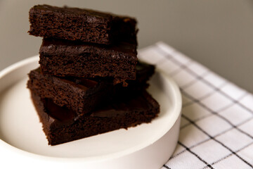 Chocolate brownies laid out on a plate, cake. Healthy banana and cocoa dessert. Health and weight care
