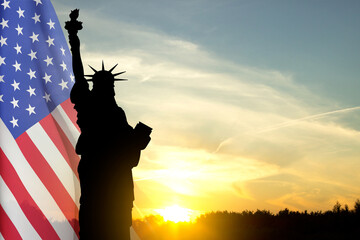 Silhouette of Statue of Liberty against the sunset. Background for Independence Day or National...