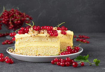 Bento cake with lemon cream and berries on dark gray background
