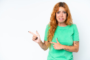 Young caucasian woman isolated on white background frightened and pointing to the side