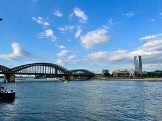 Naklejka premium The shore of Rhine river and the Hohenzollernbrücke bridge in COlogne, Germany.