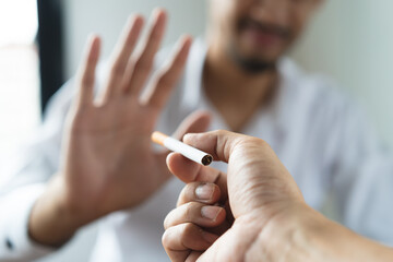 Close up hands of person refusing to smoke cigarette. - Powered by Adobe