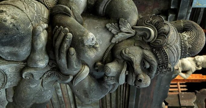 Establishment slow motion shot of a religious sculpture in bali at tirta empul temple indonesia in ubud. Vertical shot for social media