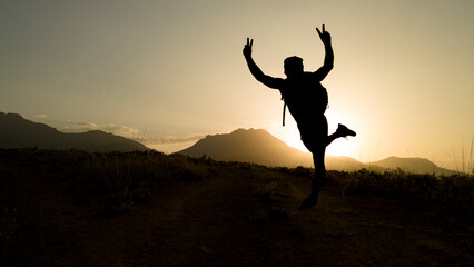 dynamic, enthusiastic and active person making a victory sign