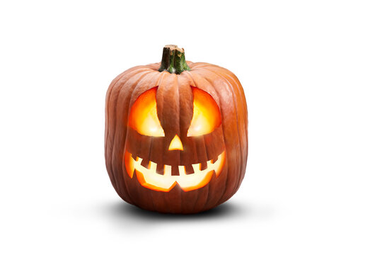 A single lit spooky halloween pumpkins, Jack O Lantern with evil face and eyes isolated against a transparent background.