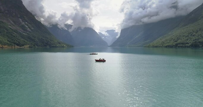 Slow flying over a beautiful fjord with boats.