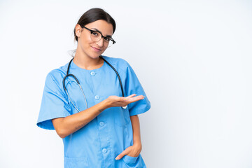 Young nurse woman isolated on white background presenting an idea while looking smiling towards