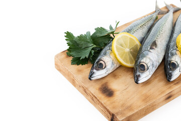 Raw mackerel fish on cutting board isolated on white background. Copy space