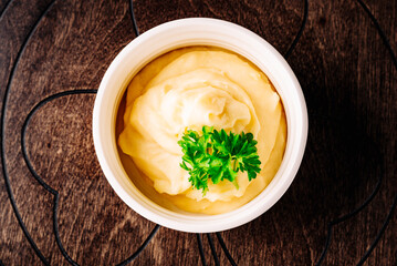 Fresh creamy mashed potato in white bowl on table