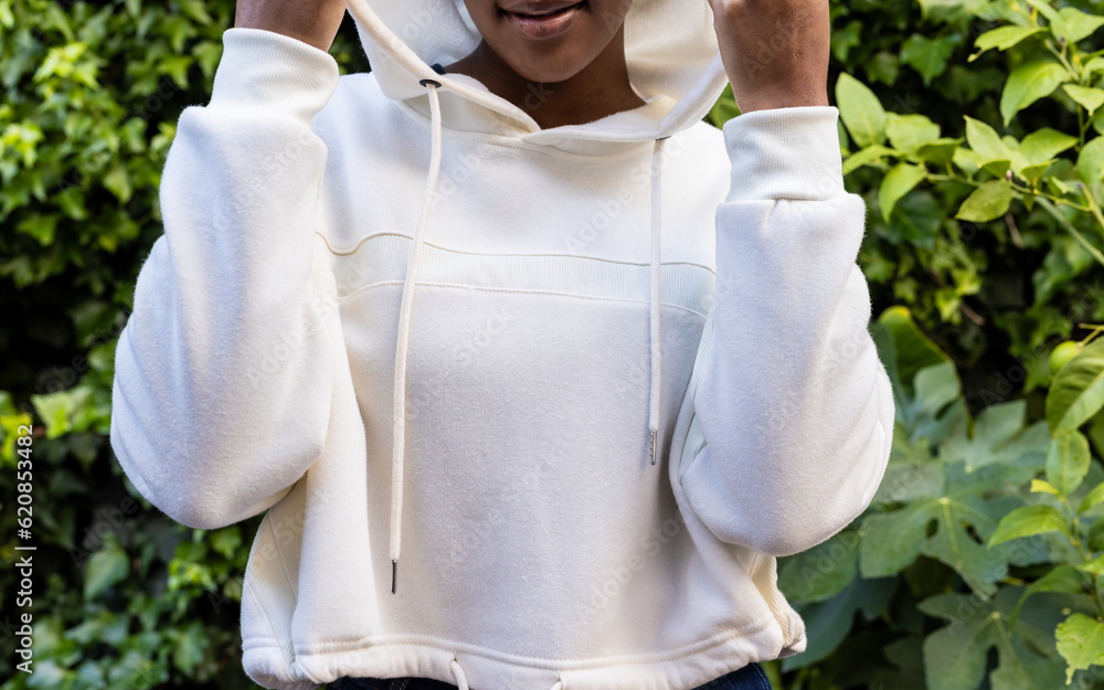 Canvas Prints Midsection of african american woman wearing white hooded sweatshirt in garden