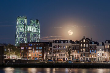 Full moon over North island in Rotterdam with the historic railway bridge