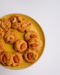 Homemade almond cookies on a plate on white background