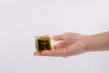 Mini gift box in hand on white background