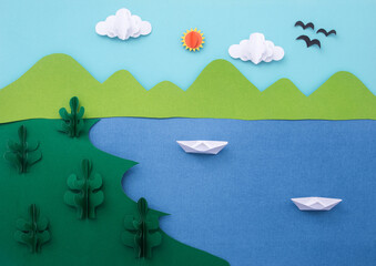 Obraz na płótnie Canvas Paper art landscape background. Mountain with sea and beach made of paper cut. summer concept.