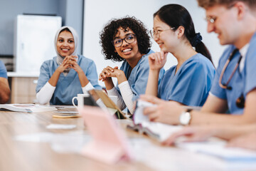 Class of diverse medical students learning and discussing in a university library