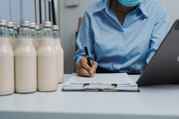Expert control quality milk factory worker checking milk bottle quality control procedure, Dairy...