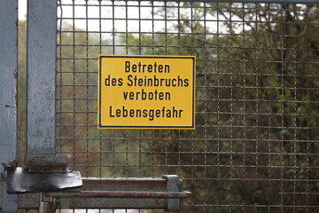 Schild mit Aufschrift Betreten des Steinbruchs verboten Lebensgefahr