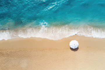 Fototapeta na wymiar White beach umbrella on sandy coast near sea, top view