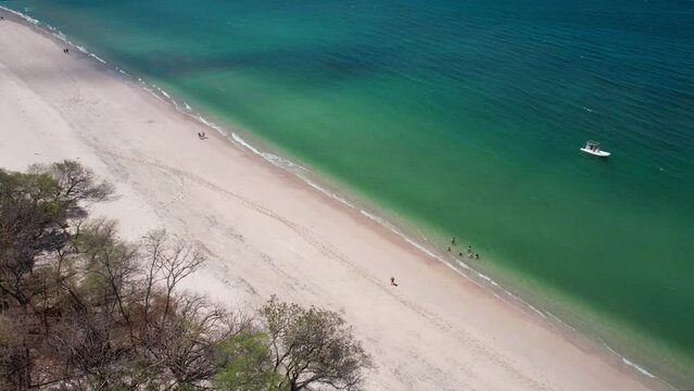 White Sand And Blue Ocean Scenery Of Conchal Beach, Costa Rica, 4K Drone Zoom Into Water