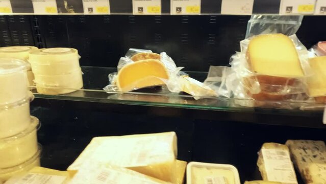 Various French cheeses in the marketplace, close-up dolly shot