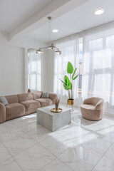living room with soft beige furniture in a light luxury interior design of a modern apartment in a...