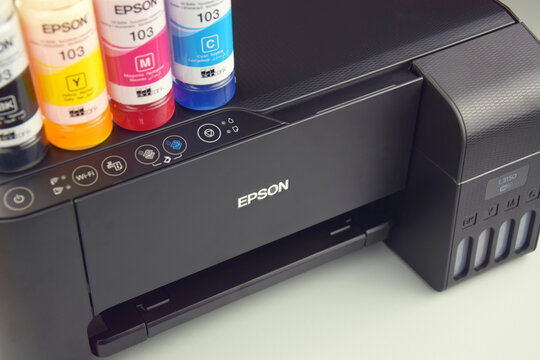 Four bottles of ink Epson, yellow, red, blue, black, built-in to the Epson L3150 series printer.